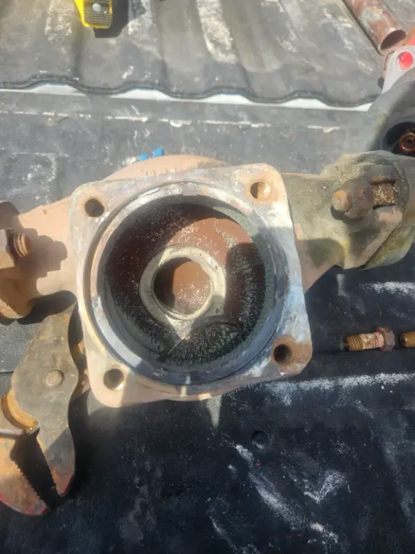 Backflow preventer body opened on a truck bed, showing the seat and internal passage