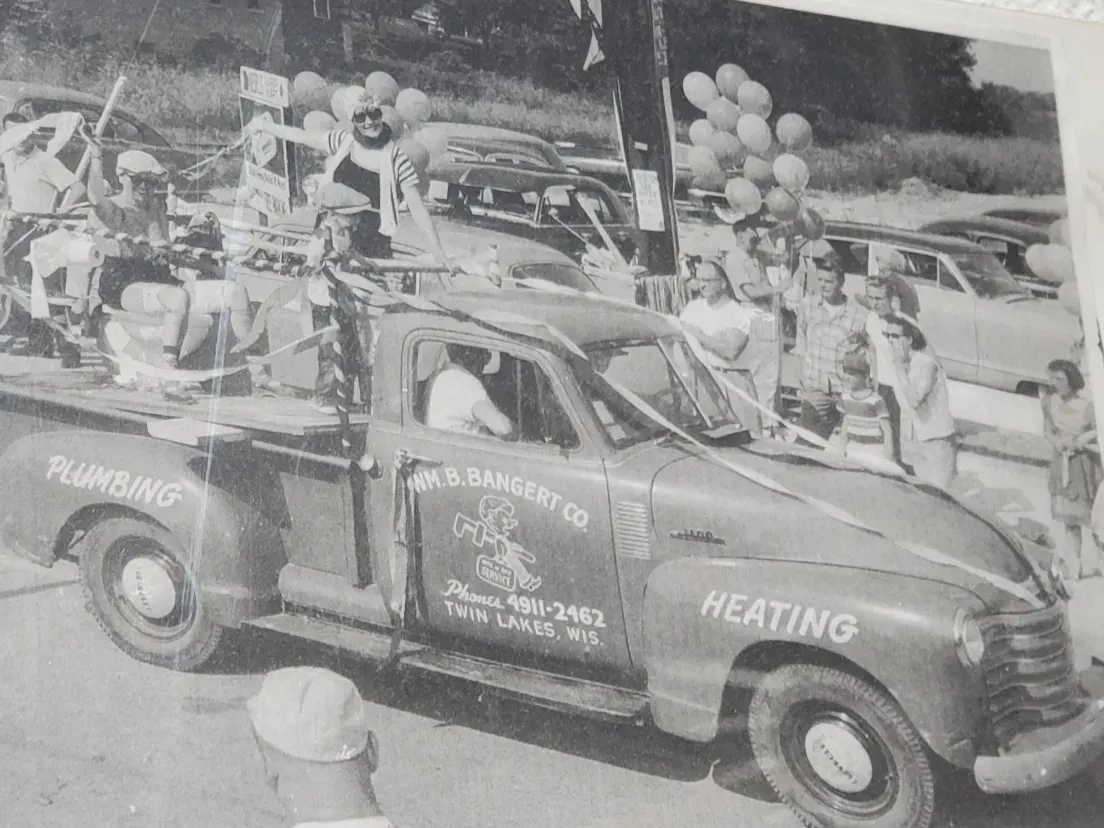 Archive photograph of a Wm. B. Bangert Co. plumbing and heating truck in a 1950s Twin Lakes, Wisconsin parade