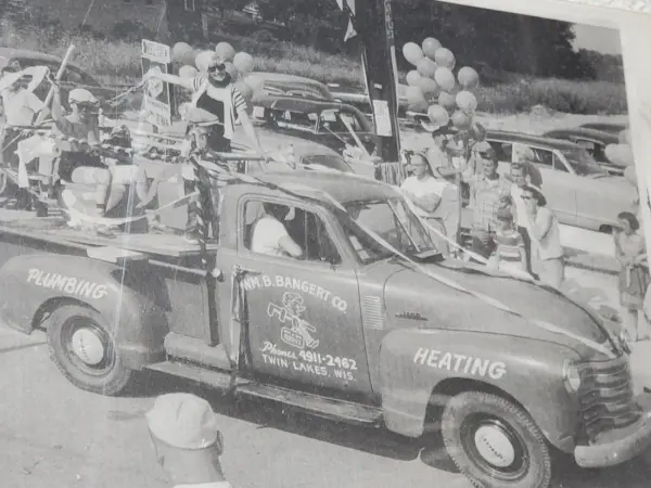 Archive photograph of a Wm. B. Bangert Co. plumbing and heating truck in a 1950s Twin Lakes, Wisconsin parade