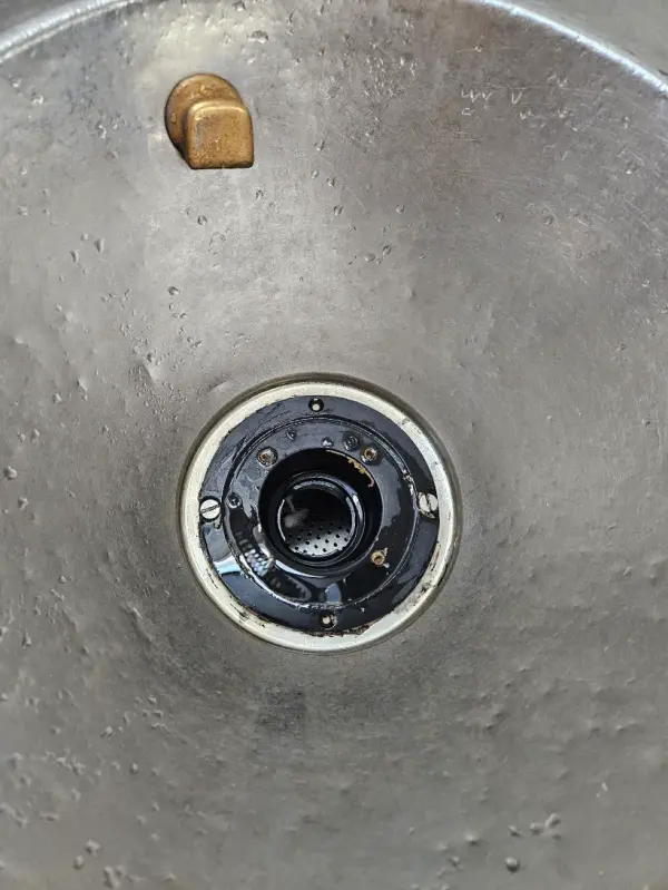 Commercial floor sink with the strainer removed during drain service
