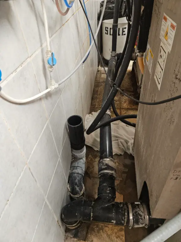 New ABS waste and vent piping run behind a commercial ice machine