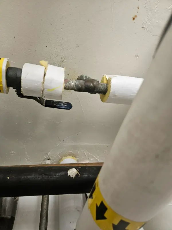 Insulated domestic water line with a Nibco shutoff valve at a wall penetration