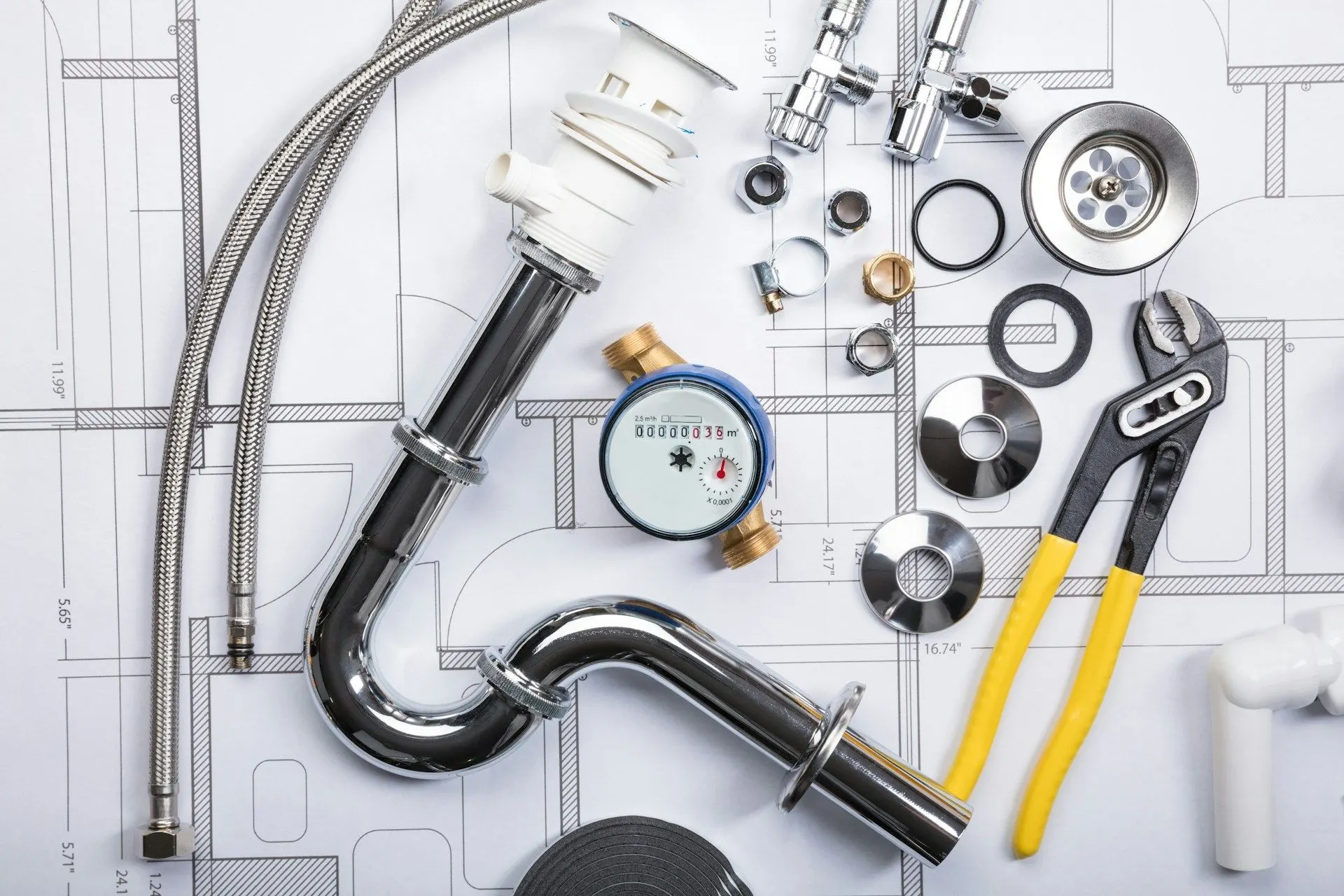 P-trap, water meter, supply hoses and plumbing tools laid out on a floor plan