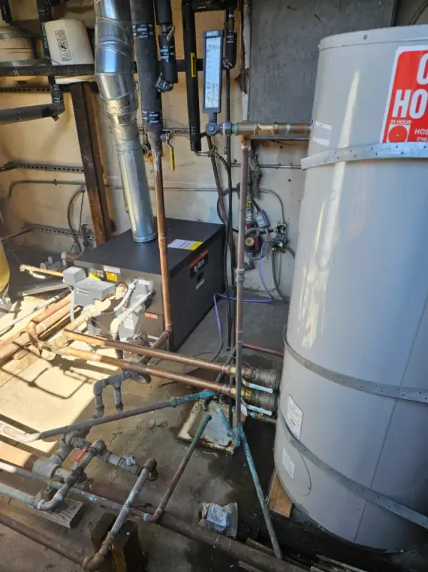 Water heater, boiler and copper distribution piping in a residential mechanical room