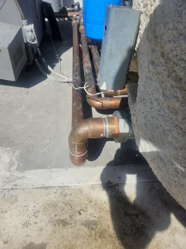 New copper supply and return lines turned into a rooftop equipment wall through a union
